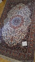 Full view of rug showing central medallion and border pattern