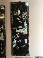 Full vertical view of the lacquered black rectangular wall panel with mother of pearl detailed design showing pagoda, flora and fauna.