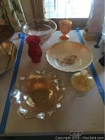 Top-down view of all six glass pieces arranged on table with window light