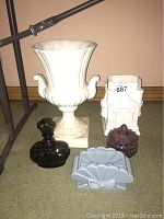 Overview of the five decorative items together: two ceramic planters, Victrylite purple glass bottle, amethyst hobnail candy dish, and another glass item.