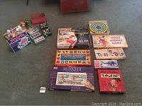 All items displayed showing the vintage boxed board games laid out with vintage candles and Christmas ornaments grouped together.