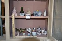 Full shelf shot showing various vintage figurines and mini vase
