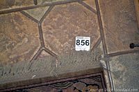 Close-up of the worn fringe and corner details showing wear and condition of the rug.