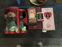 Five boxed Barbie items including two Special Edition Holiday Barbies in green gowns, Barbie stocking hanger box, Barbie Keepsake ornament box, and Sweet Valentine Barbie box.
