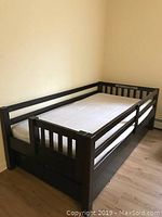 Twin bed frame with under-bed trundle storage drawer and mattress