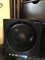 Black Honeywell QuietSet table fan with circular blade guard and control buttons on front lower panel