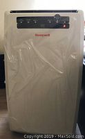 Front view of white Honeywell portable air conditioner with LED control panel