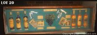 Full view of the shadow box showing all contents including bottles, photos, plaques, and accessories on teal fabric background