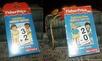 Front of addition and subtraction flash card boxes showing the Fisher Price branding, age recommendation and card themes