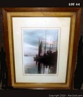 Full view of the framed photograph showing the image of fishing boats at sunset/sunrise with wooden frame and matting.