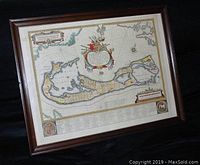 Framed reproduction map in wood frame, showing an overview of The Bermudas islands with detailed cartography and a decorative cartouche.