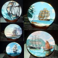 Five collector plates on display stands showing paintings of sailing ships at sea, round plates with detailed sail and sea depictions. Blue sea and sky backgrounds.