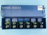 Box open showing five dark green glass candlestands inside with separated slots, Dansk Designs original blue box with some damage.