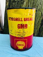 Front of the Shell Aeroshell Grease Can showing bold yellow and red colors with text and Shell logo.
