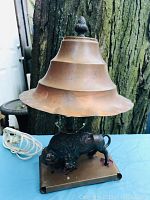 Full view of the lamp with copper shade and buffalo base, showing overall shape and condition.