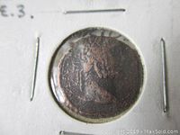 Close-up photo of the ancient Roman bronze coin showing obverse side with emperor profile bust