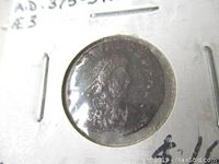 Photo of ancient Roman coin in protective holder showing obverse with Emperor Valentinian II profile