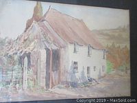 Front view of framed watercolour painting depicting a rural cottage scene in muted pastel colors