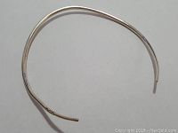 Cuff-shaped 925 sterling silver necklace, visible marking '925' on end, smooth polished surface, curved open-ended design