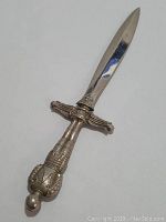 Sterling silver letter opener showing detailed sword-shaped handle and polished blade with pointed tip