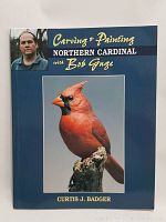 Front cover featuring a realistic carved and painted Northern Cardinal with portrait of Bob Guge.