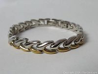 Close-up photo showing the two-tone design of the sterling silver bracelet with 925 mark , capturing the link pattern and clasp