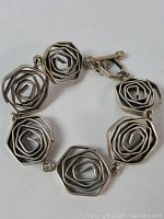 Photo of vintage sterling silver bracelet showing petal circle spiral link design and toggle clasp