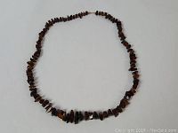 Full view of the raw amber necklace laid flat showing the entire length and bead arrangement.