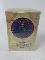 Front view of one sealed deck of playing cards, showing Defense Intelligence Agency emblem and issuance text.