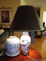 Photo showing both the ceramic base lamp with blue floral and bird design and the blue and white decorative vase with plate side by side.