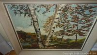 Photo showing the framed oil painting with birch trees and autumn foliage in a landscape format.