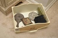 Photo showing antique and vintage beaded purses, hand mirror, metal jewelry box, and Limoges trinket box inside a Parfums storage box