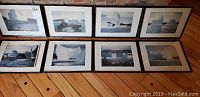Eight black-framed photographs of icebergs arranged in two rows on a wooden surface, showing diverse iceberg formations and maritime scenery.