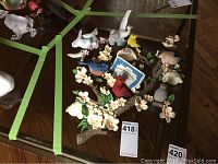 Top view of Bradford Exchange Garden Delights bird statuettes showing multiple small birds on a flowering branch with white blossoms.