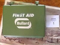 Olive green Bullard first aid kit with handle and branding on lid