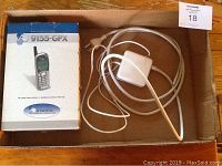 Box of Audiovox 9155 GPX wireless phone and Apple charger with cable in cardboard box.
