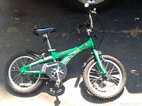 Full view of the green Schwinn Safari bike showing the frame, wheels, handlebars, seat, and pedals in good condition.