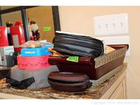 Tray with various items including metal basket, black cases, carnival tickets