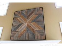 Front view of large square wood wall art with geometric design