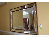 Rectangular beveled wall mirror with bronze faux pin head bead frame, showing full view and wall mounting.