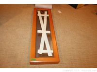 Top view of the jewelry case showing the wooden frame and glass front in an unassembled state on carpeted floor.