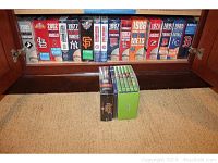 Shelf displaying multiple boxed baseball team DVD sets featuring various MLB teams and years.