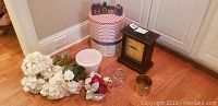 Full lot including mantel clock, faux flowers, ceramic pot, two hat boxes, brass and glass vases arranged on floor