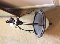 Photo of the metal and glass chandelier showing the entire fixture from the bottom angle on carpet flooring.