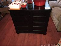 Front view of black solid ash wood compact office with closed doors showing horizontal recessed handles.