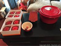 Entire lot on black table: boxed soup tureens, mortar and pestle, rectangular pan, covered pot