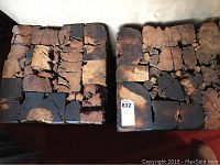 Top view of two square side tables showing the cracked, textured natural wood surface with varying tones of brown and black.