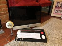 Front view of iMac screen with Macally keyboard box and Blue Snowball microphone