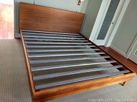 Full assembled bed frame showing headboard, side rails and slats
