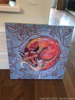Full view of the 20x20 inch canvas painting showing a curled sleeping fox with bright colors on a light blue background with red floral patterns.